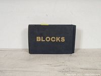 Front cover of black booklet with gold 'BLOCKS' text