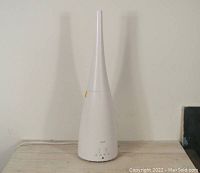 Side view of assembled humidifier with tall, narrow nozzle attached