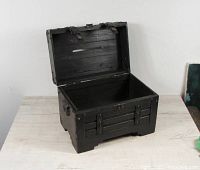 Black wooden box with open hinged lid showing the slot on the top and interior space.