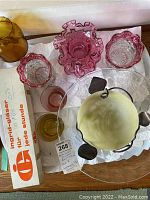 Group photo showing multiple art glass items including cranberry glass vases, frosted glass bowl, amber vase and pink glass bowl.