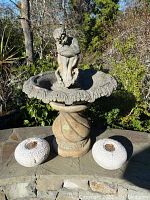 Full lot view showing birdbath and two spherical ornaments on stone ledge