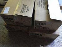 Four cardboard boxes labeled Libbey containing stemware glasses, stacked and sealed.