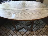 Oval tabletop view showing wood grain and natural finish