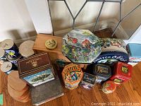 Photo shows an assortment of vintage food collector tins including Pretzels, Bassett's, Ritz, Pears Soap, and Premium Cornflakes along with wooden nesting boxes and a Crabtree & Evelyn decorative box.