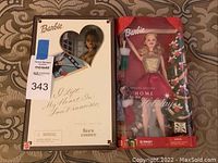 Both Barbies in original boxes, front view showing packaging and doll visibility.