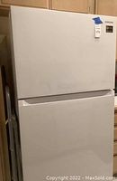 Front view of closed Samsung top-freezer refrigerator showing overall condition