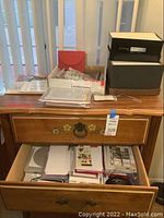 Photo of table holding assortment of boxed cards, envelopes, and stationery.