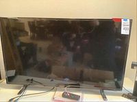 Front view of Westinghouse 41" TV with screen off, showing its size and condition on a white surface.