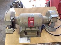 Overview of Wissota bench grinder, model E-6 with grinding wheels on each side and protective guards.