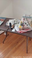 Serger on foldable table with manuals, tools and pedal