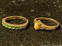 Both rings side by side showing yellow cabochon and green faceted stones