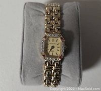 Front view of the gold-tone ladies GENEVE watch showing the rectangular dial with rhinestones and quartz label.