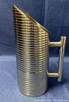 Side view showing cylindrical ribbed design and handle of stainless steel water pitcher