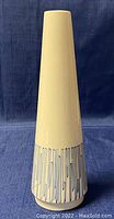Front full view of the tall cone-shaped vase with blue linear decoration on white background.