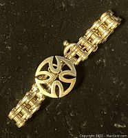 Close-up of central round medallion with cut-out motif on black background