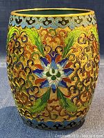 Front view of vintage champlevé cloisonné enamel planter/vase showing detailed colorful floral and scroll patterns with gold accents.