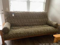 Front view of futon sofa bed showing full piece and wood frame