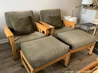 Overall view of two armchairs and two ottomans in room setting