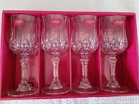 Full view of 4 crystal glasses in original red packaging with sticker label