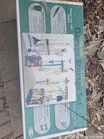 Photo of the box's top displaying the full 6-piece set and sample usage images of racks, clips, and bags for organizing garden tools.