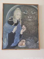 Framed oil painting depicting a girl with a large cat and pastries, titled 'Bohemot i Malgorzata'.
