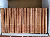 Front view of 18 brown leather-bound volumes with gold embossed spines labeled 'Works of Scott' and individual volume titles.