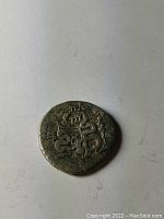 Obverse view showing calligraphic inscription and dot motifs