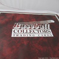Front cover of the baseball collectors album showing maroon textured background with the words 'Baseball Collectors Trading Cards' stamped in white and black ink.