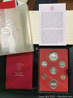 Photo showing the full RCM 1973 Specimen Coin Set with coins in red velvet tray inside black case with RCM branded documentation and red pouch.