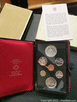 Photo of the entire coin set in red Royal Canadian Mint protective case showing all coins and informational insert