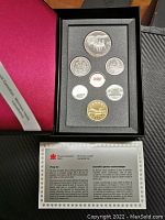 Full view of seven-coin proof set in original black foam tray with display box and Royal Canadian Mint documentation.