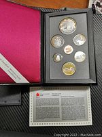 Full set of 7 coins in black foam display case, maroon interior cover, with Royal Canadian Mint certificate visible below.