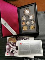 Image of the full case with all coins displayed and Royal Canadian Mint pamphlet.