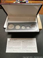 Set of five 1998 Canadian coins with antique finish displayed in a fitted case with Certificate of Authenticity placed in front.
