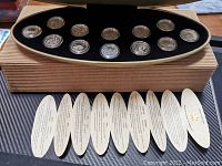 View of all 12 silver proof quarters displayed in a black velvet-lined case with a certificate of authenticity booklet.
