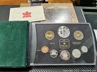 Full set photo showing all eight coins in protective casing with green velvet box and original packaging.