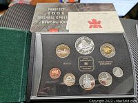 Display case showing full 2003 Canadian Proof Coin Set including special edition dollar and supporting documentation.