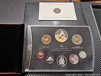 Set of Canadian 2009 proof coins in acrylic case, including various denominations and a special edition silver dollar coin in black display box.