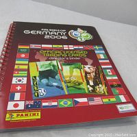 Front cover of the spiral-bound FIFA World Cup Germany 2006 official licensed trading card binder showing colorful flags and logo.