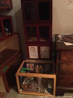 Stack of three empty wooden and plexiglass diorama cases, stained reddish wood, visible plexiglass fronts.