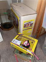 Boxed Breyer's One Stall Barn and Breyer Stable Cleaning Kit in original packaging with Breyer Foal visible underneath
