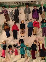 Top-down view of two rows of adult and teen dolls showing overall layout
