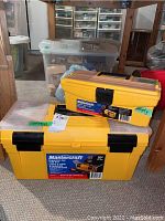 Two yellow Mastercraft tool boxes stacked, larger box measures 20" x 9" x 8" with clear organizer top, smaller box marked empty