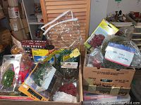 Photo of assorted packaged miniature trees in boxes and plastic bags, showing variety of tree types and brands.