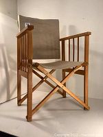Front and side view of the folding director's chair showing maple wood frame and canvas seat/backrest