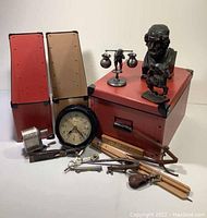 Overall view of collection showing Homer bust, figurine, clock, drafting tools, and archival boxes