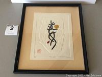 Framed embossed original print with visible artwork and frame against neutral background