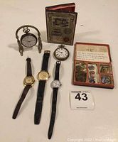 Full lot shown including watches, watch stand, Montres Croissant box, and travel medallions box