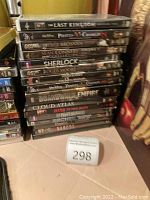 Stack of DVDs including The Last Kingdom Season Two, Pirates of the Caribbean 2, James Bond 007 editions, Sherlock, Boardwalk Empire, Cloud Atlas, Dexter, Peaky Blinders, and Narcos
