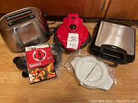 Hamilton Beach toaster, red X-Press Ready Set Go tortilla press with recipe book, and white tortilla press plates